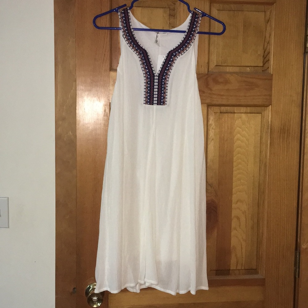 White dress with blue/red embroidery